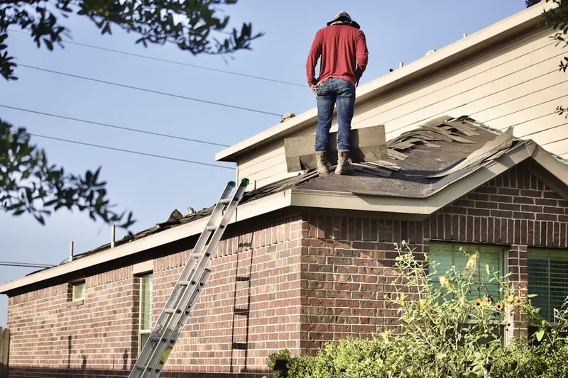 Professional roofer working on a residential roof in West Lampeter